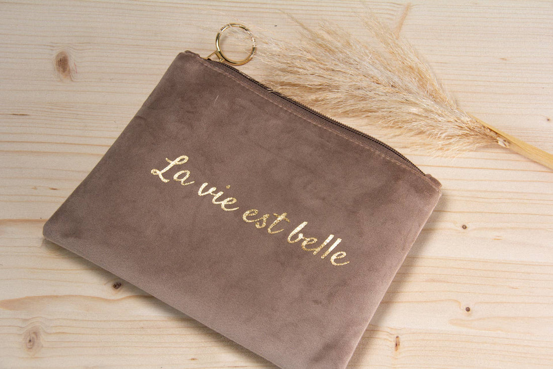 La vie est belle makeuptaske i grå velour med guld skrift