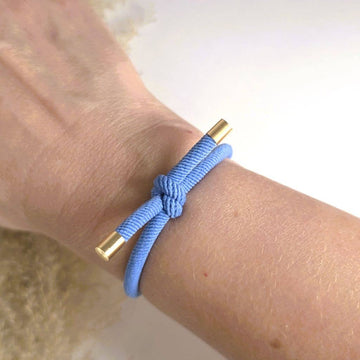 BLÅ Hårelastik og armbånd båret som armbånd om håndleddet.